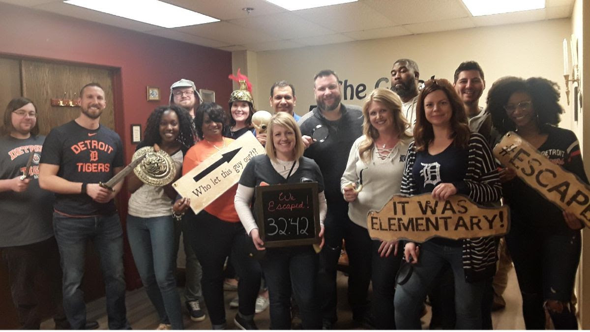 A portion of the BenXpress team standing together at an Escape Room facility. We work hard together, and have fun together!